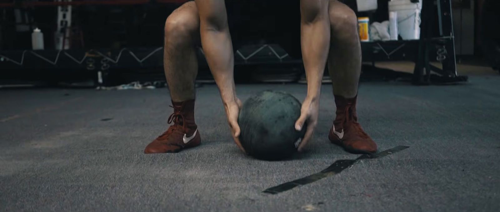 a man bending over to pick up a ball