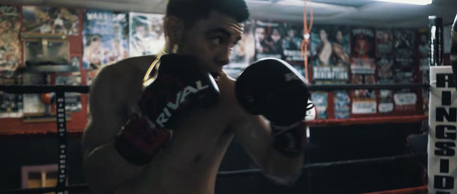 a shirtless man in a boxing ring