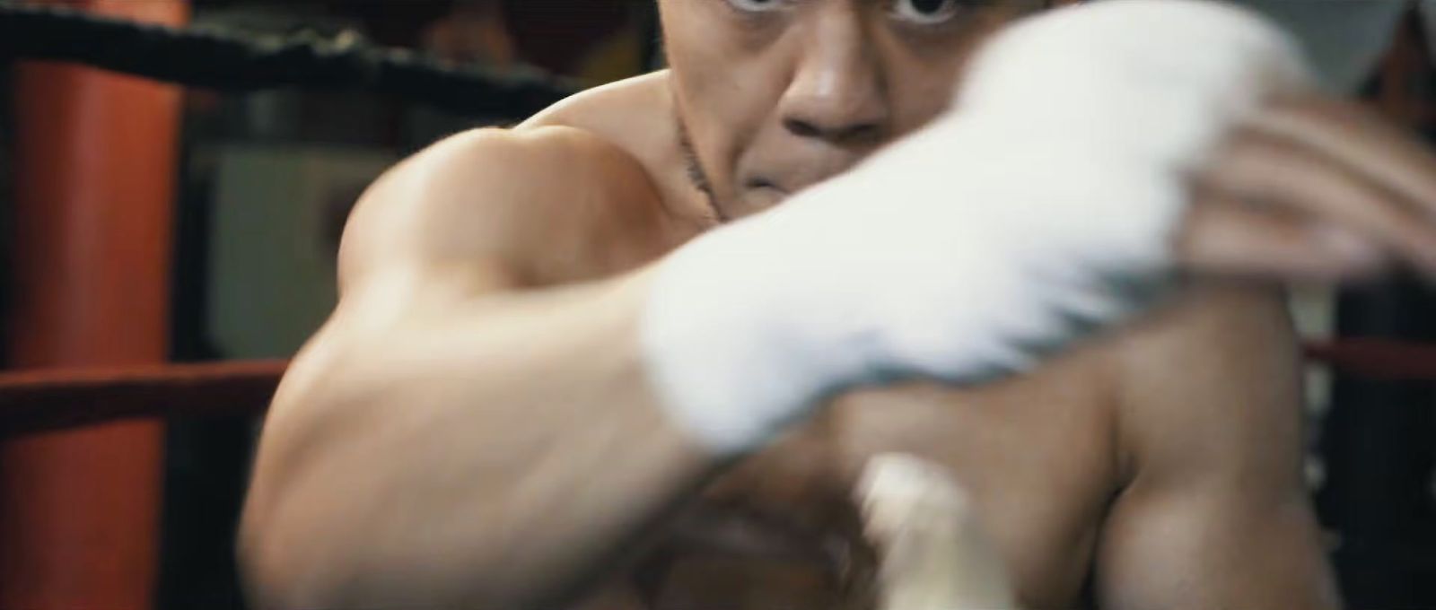 a man in a boxing ring holding a white glove