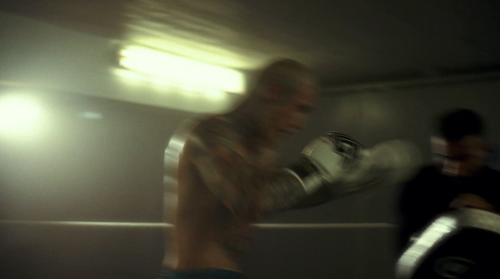 a blurry photo of two men in a boxing ring