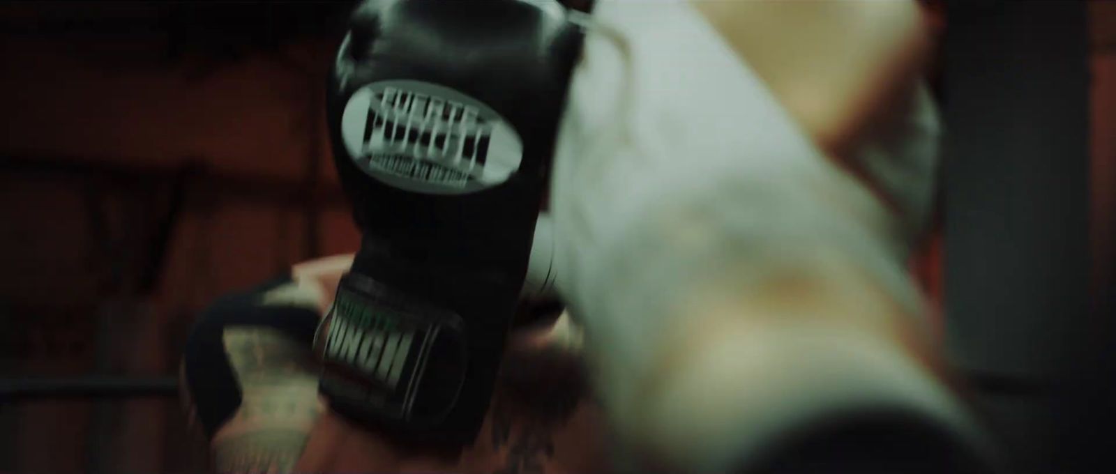 a close up of a person wearing boxing gloves