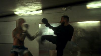 a blurry photo of two men boxing in a gym