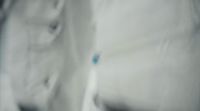 a close up of a white shirt with a blue spot on it