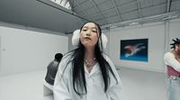 a woman with headphones standing in a room