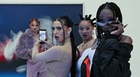 a group of women standing next to each other holding cell phones