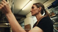 a woman is looking at something on a shelf