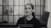 a black and white photo of a woman in a prison cell