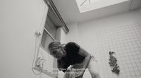a woman bending over in a bath room