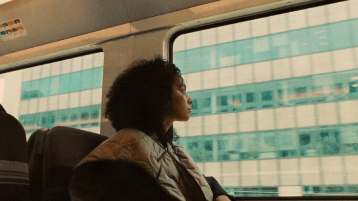 a woman sitting on a train looking out the window