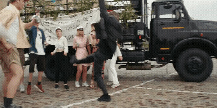 a group of people standing in front of a truck