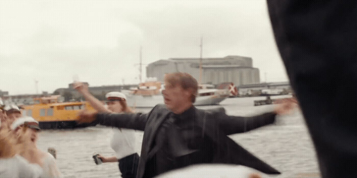 a group of people standing on top of a body of water