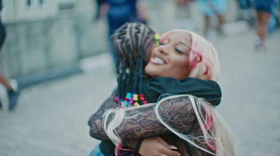 a woman hugging another woman on the street