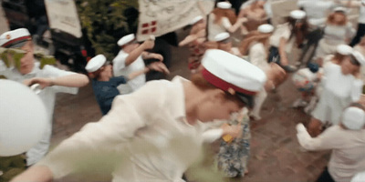 a group of people dressed in white are dancing