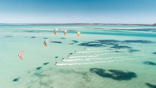 a group of people parasailing in the ocean