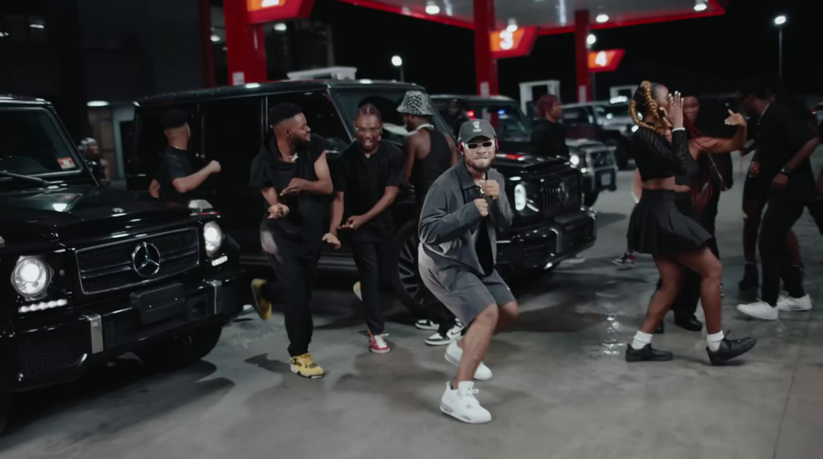 a group of people standing around a car