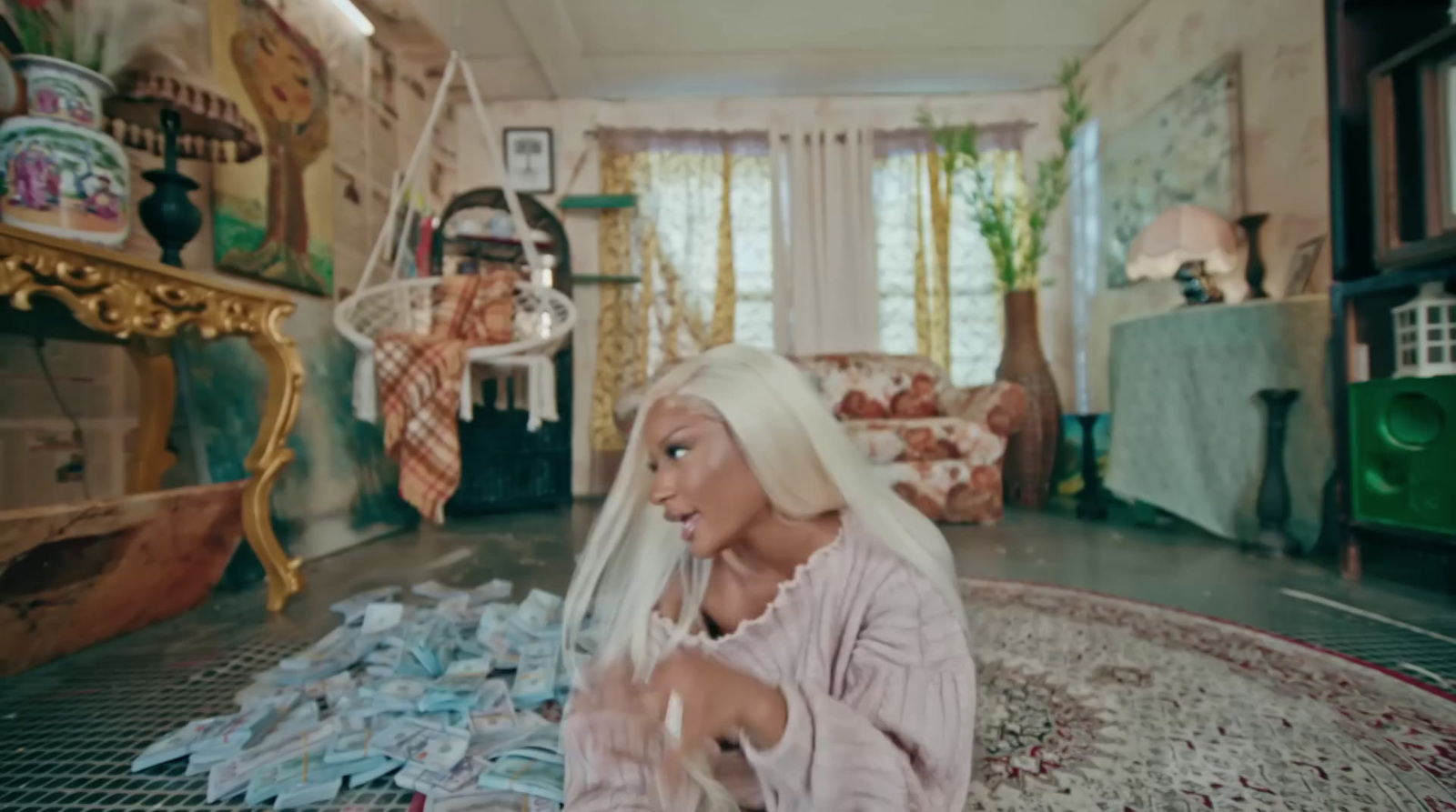 a woman with white hair sitting on a rug in a living room