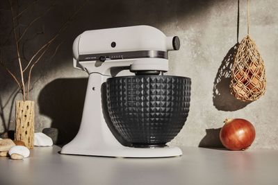 a black and white mixer sitting on top of a counter