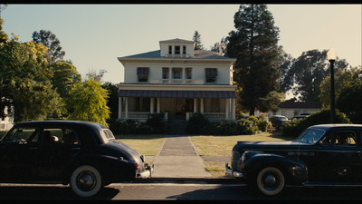 a couple of cars parked in front of a house