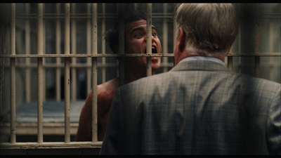 a man standing in front of a jail cell