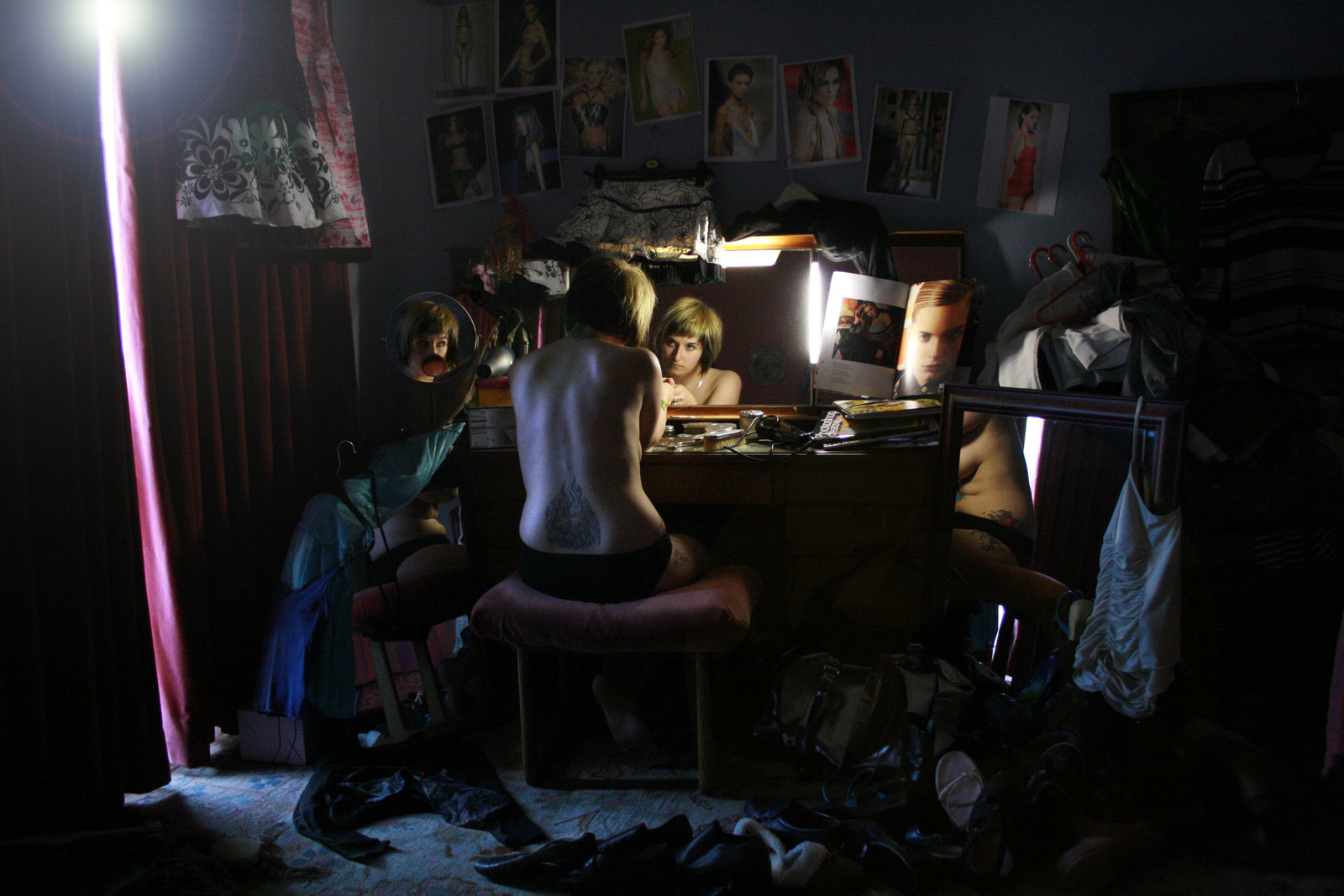 a woman sitting in a chair in front of a mirror