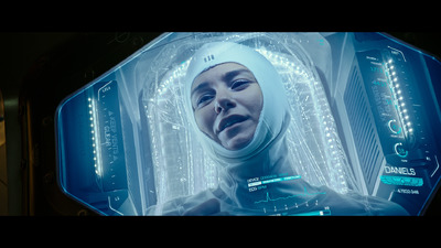 a woman in a space suit standing in front of a computer screen