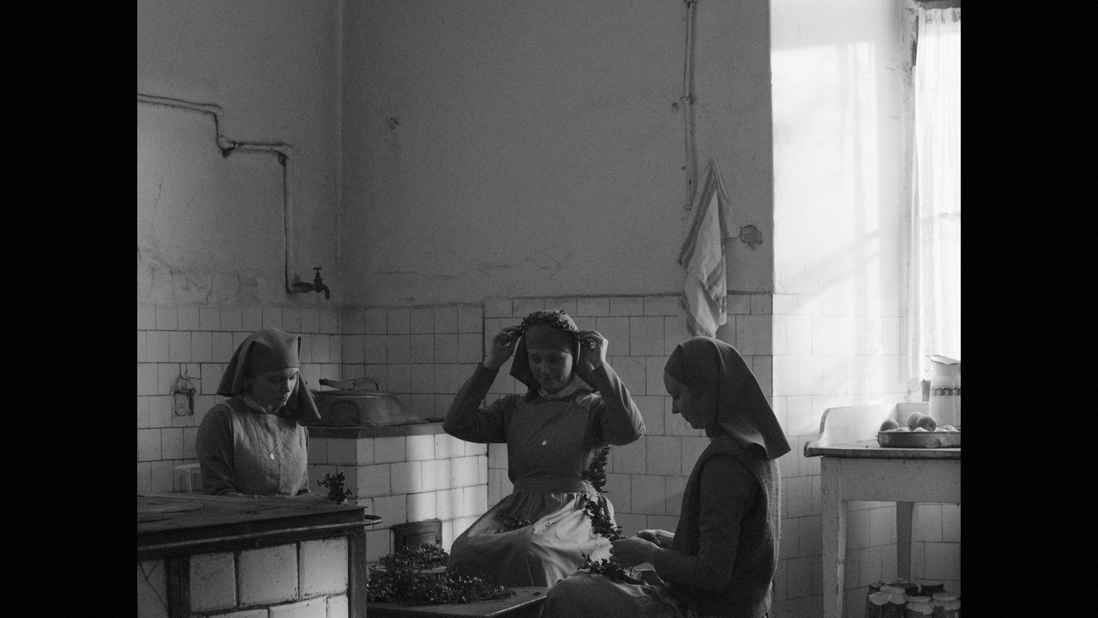 a black and white photo of two women in a kitchen