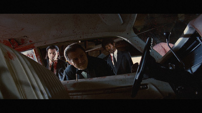 a group of men in suits and ties in a car