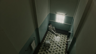 a woman sitting on the floor of a bathroom