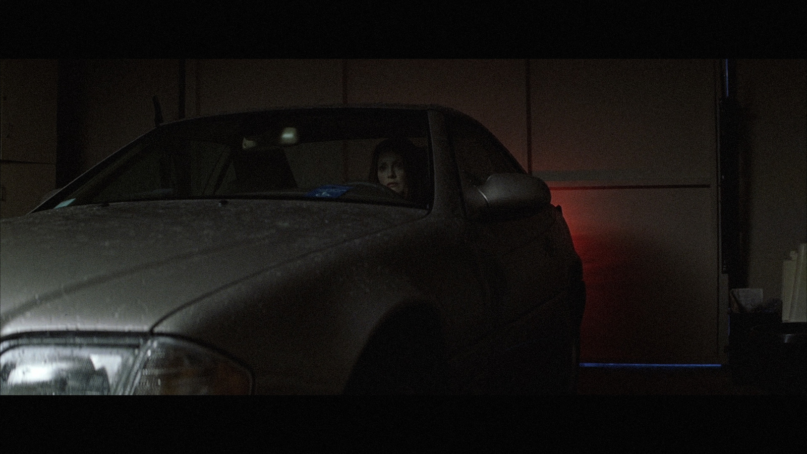 a person sitting in a car in the dark