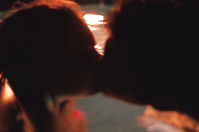 a close up of a person kissing another person