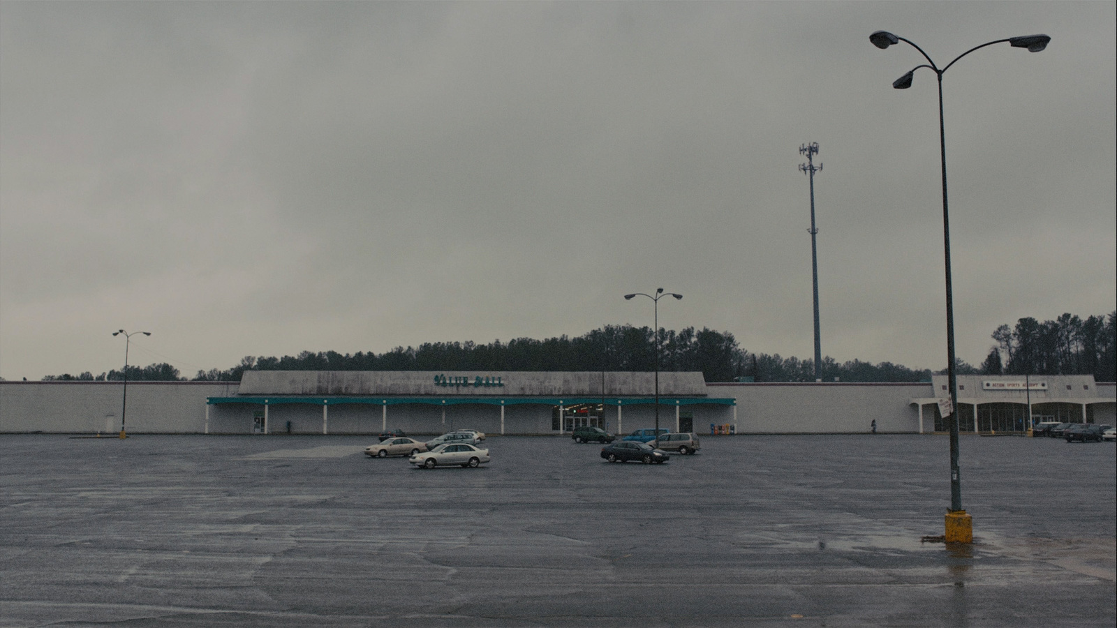 a parking lot with cars parked in front of a building