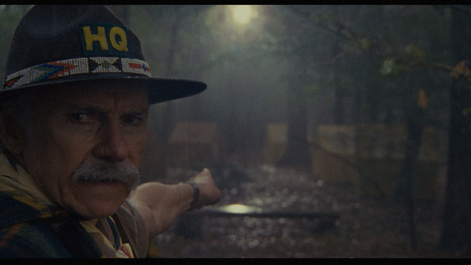 a man wearing a hat and holding a baseball bat