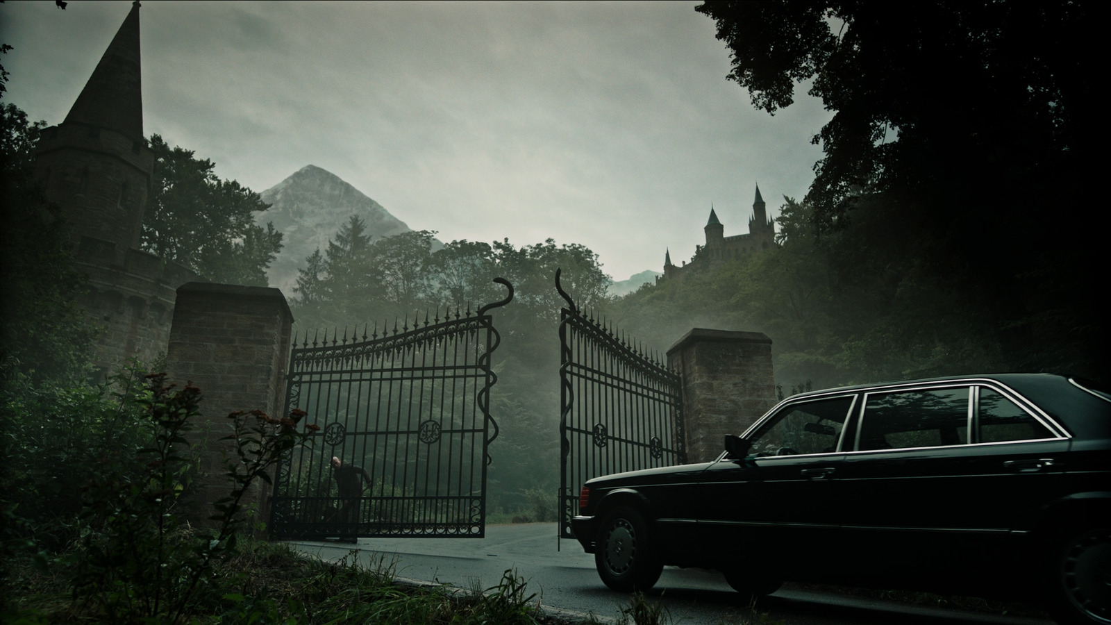 a car is parked in front of a gate