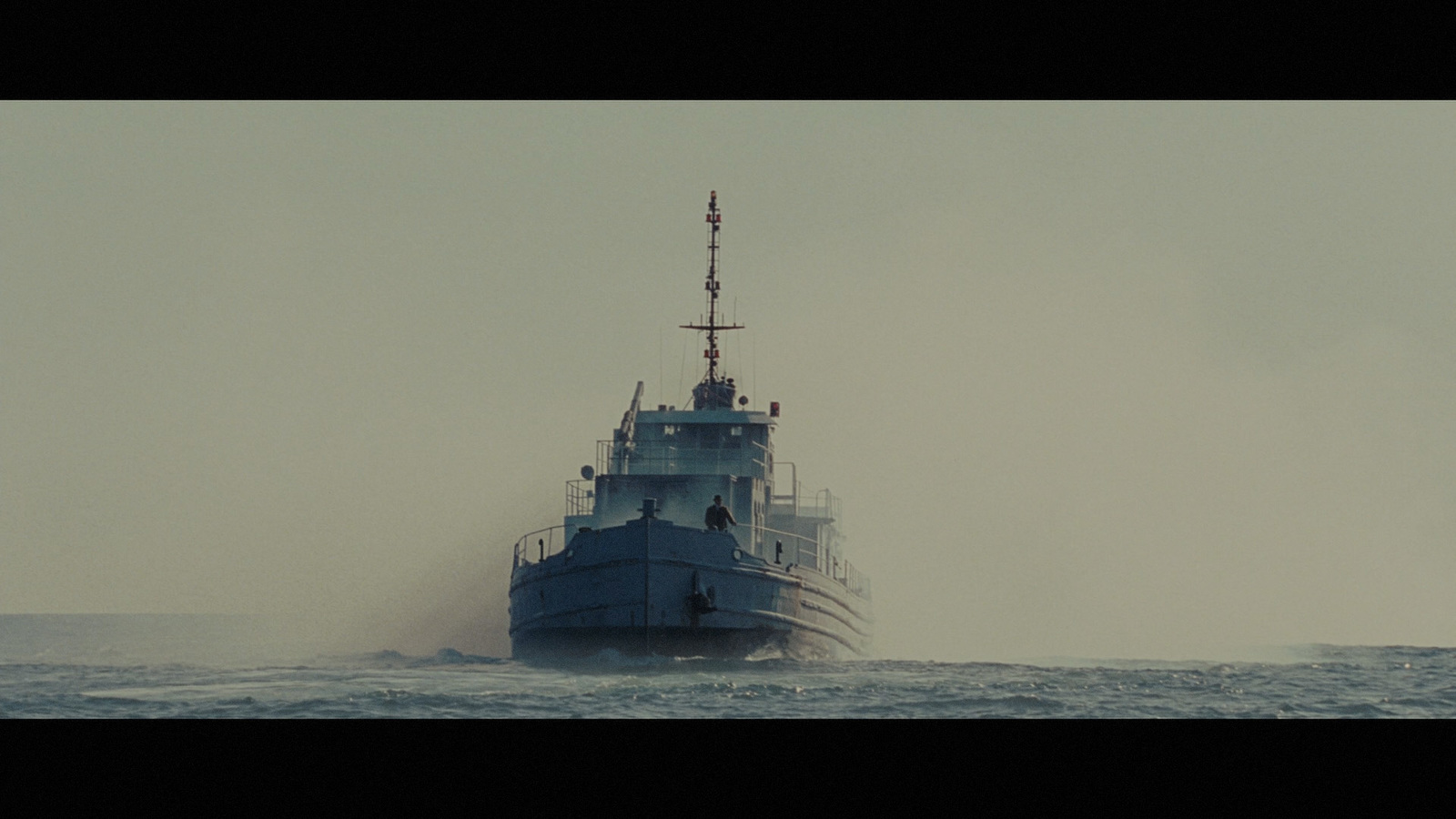 a large blue boat in the middle of the ocean