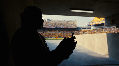 a silhouette of a man holding a cell phone