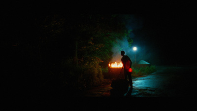 a man standing next to a car in the dark