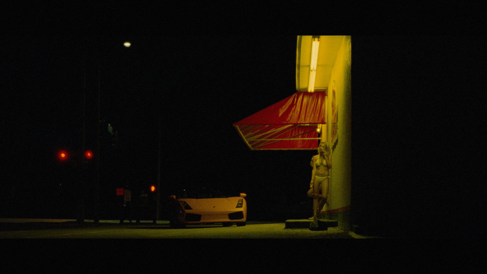 a car parked on the side of the road at night