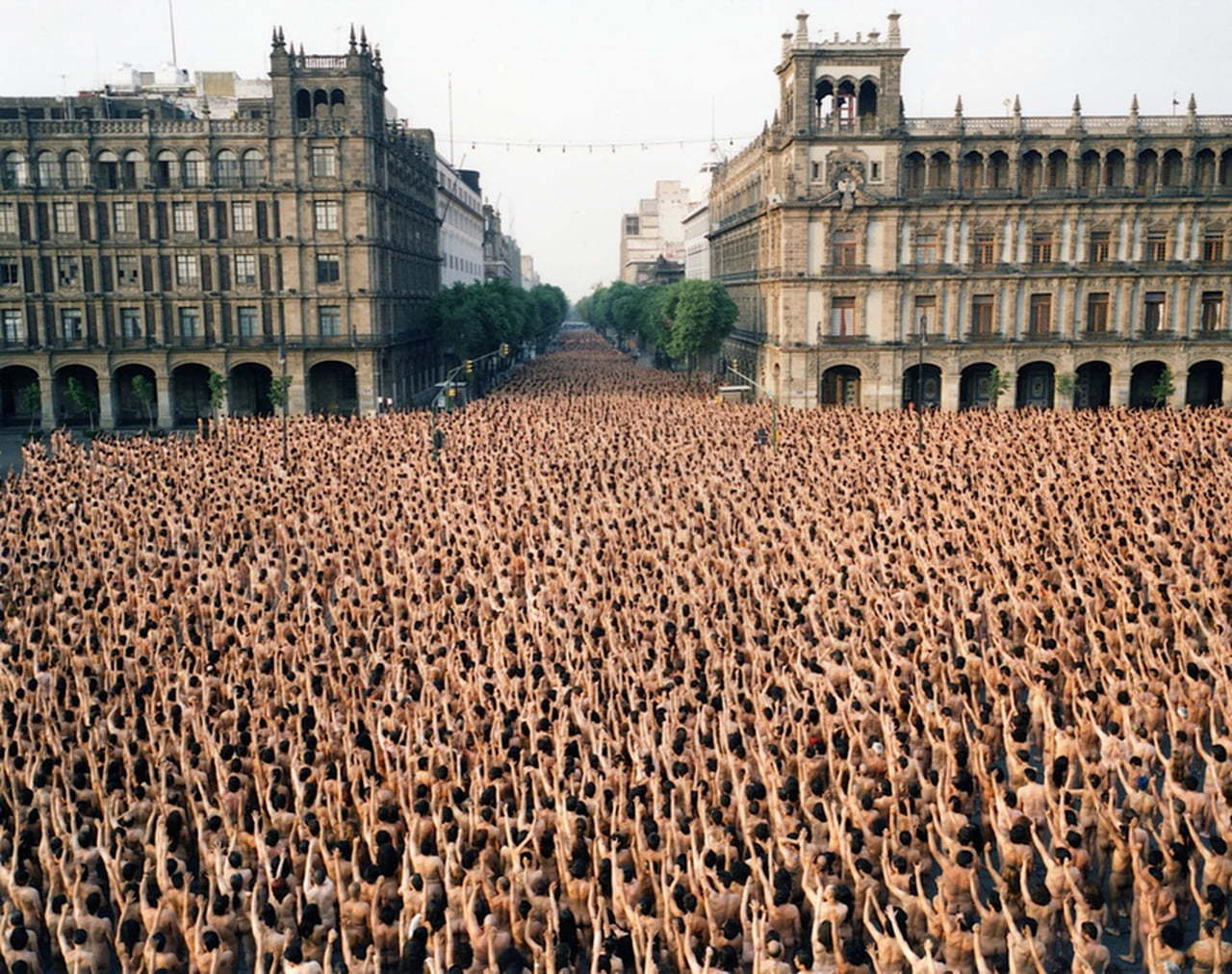 a large crowd of people standing in front of a building