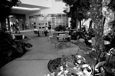 a black and white photo of people sitting at tables