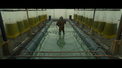 a man standing in a large room filled with yellow liquid
