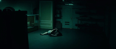 a person laying on the floor in a dark room