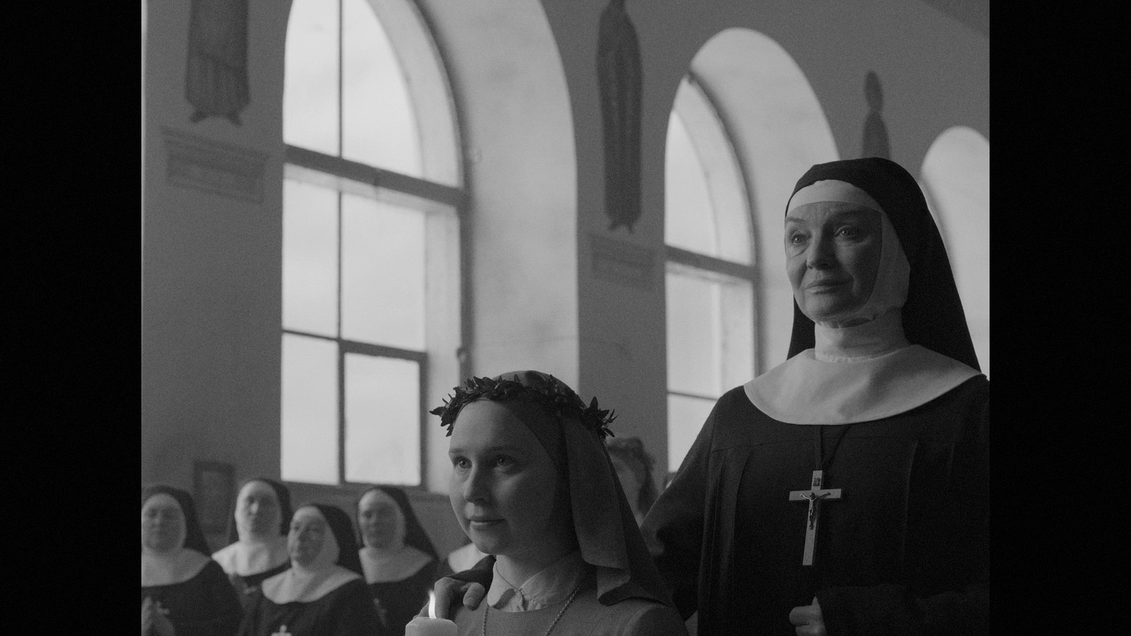 a nun and a nun standing in front of a group of women