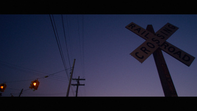 a railroad crossing sign and a traffic light