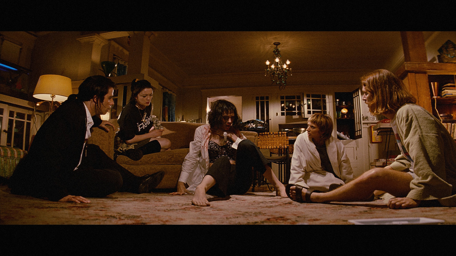 a group of people sitting on the floor in a living room