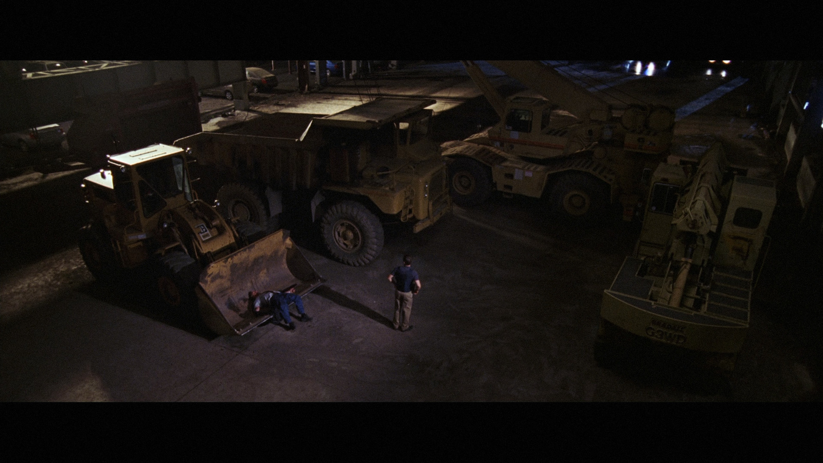 a couple of men standing next to a large truck