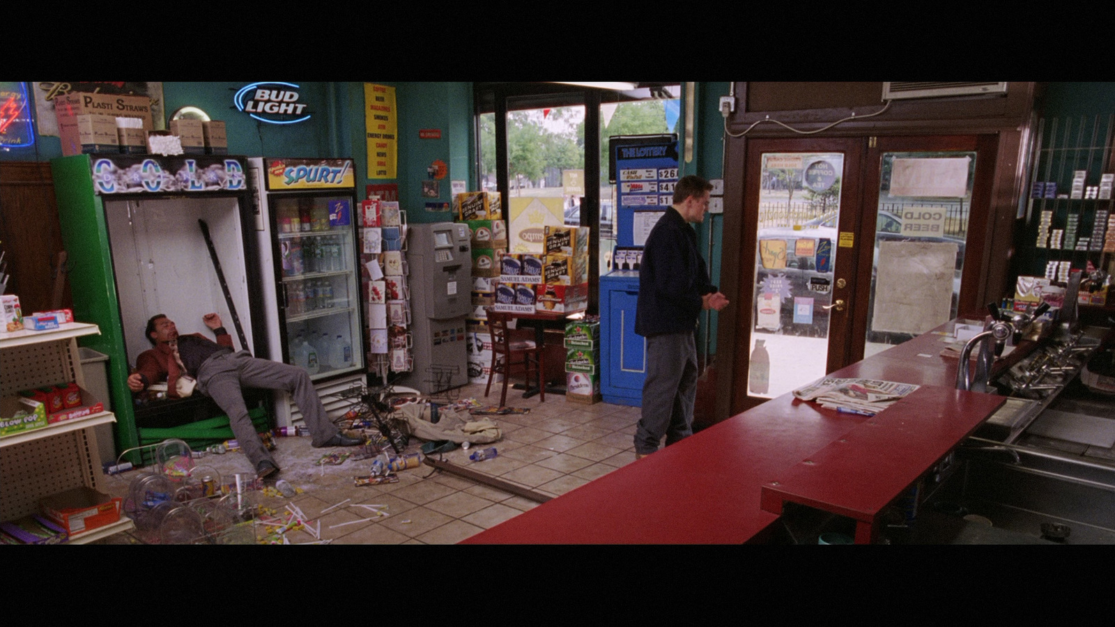 a man standing in front of a store filled with items