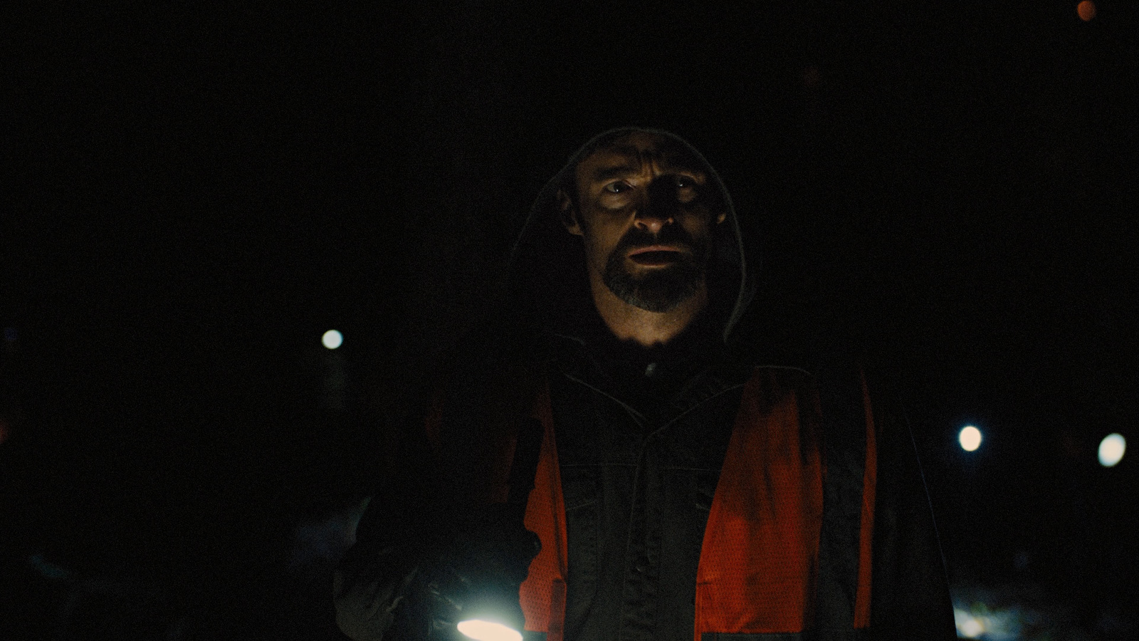 a man holding a flashlight in the dark