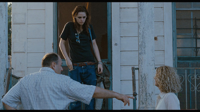 a man pointing at a woman in front of a door