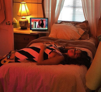 a woman laying on a bed in a bedroom