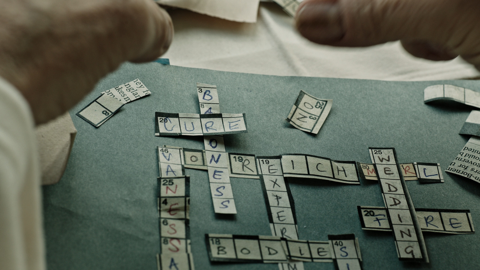 a close up of a person playing a game of scrabble